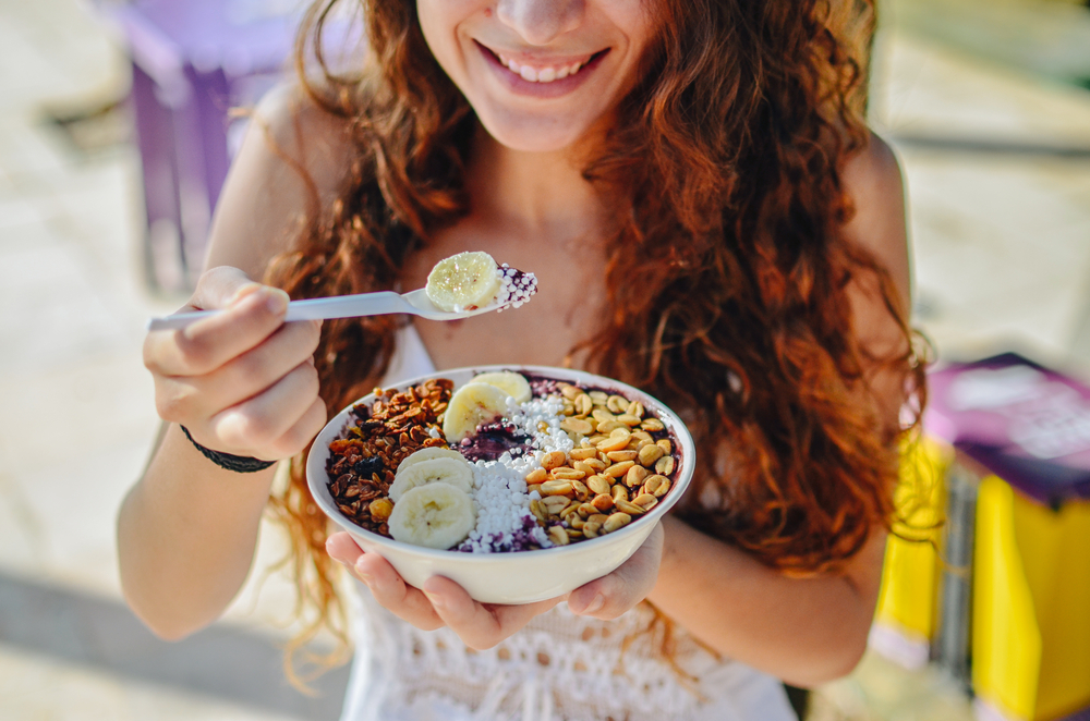 Woman enjoying acai bowl.