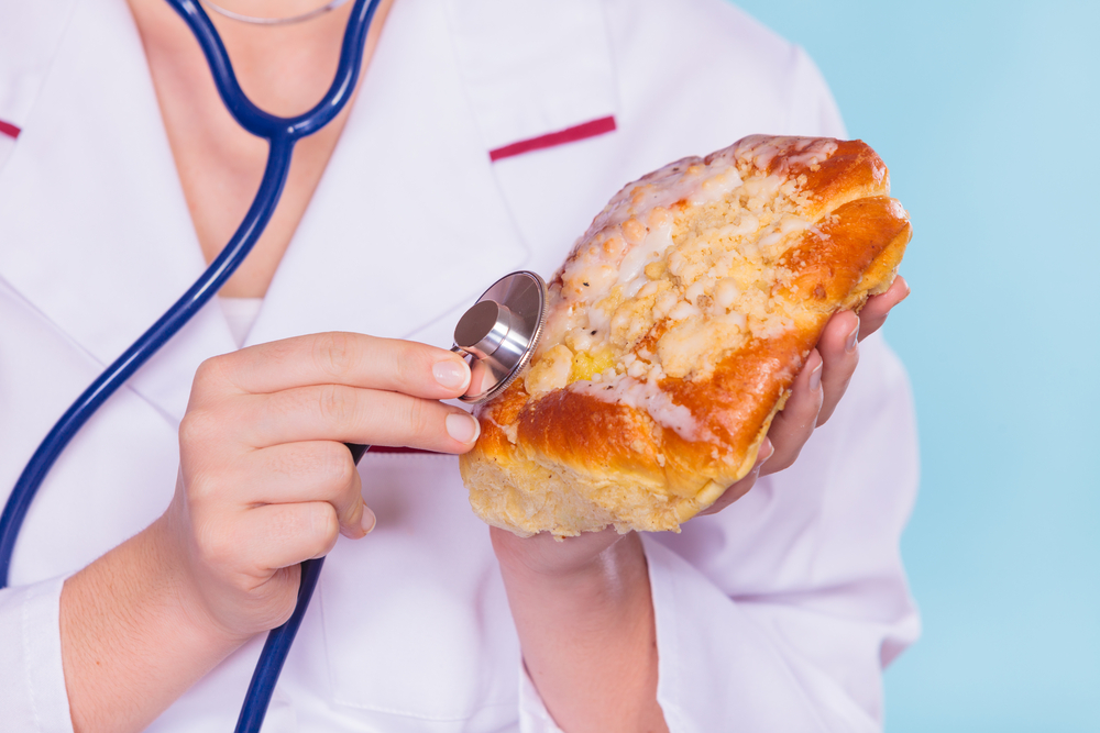 Nutritionist checking food with stethoscope.